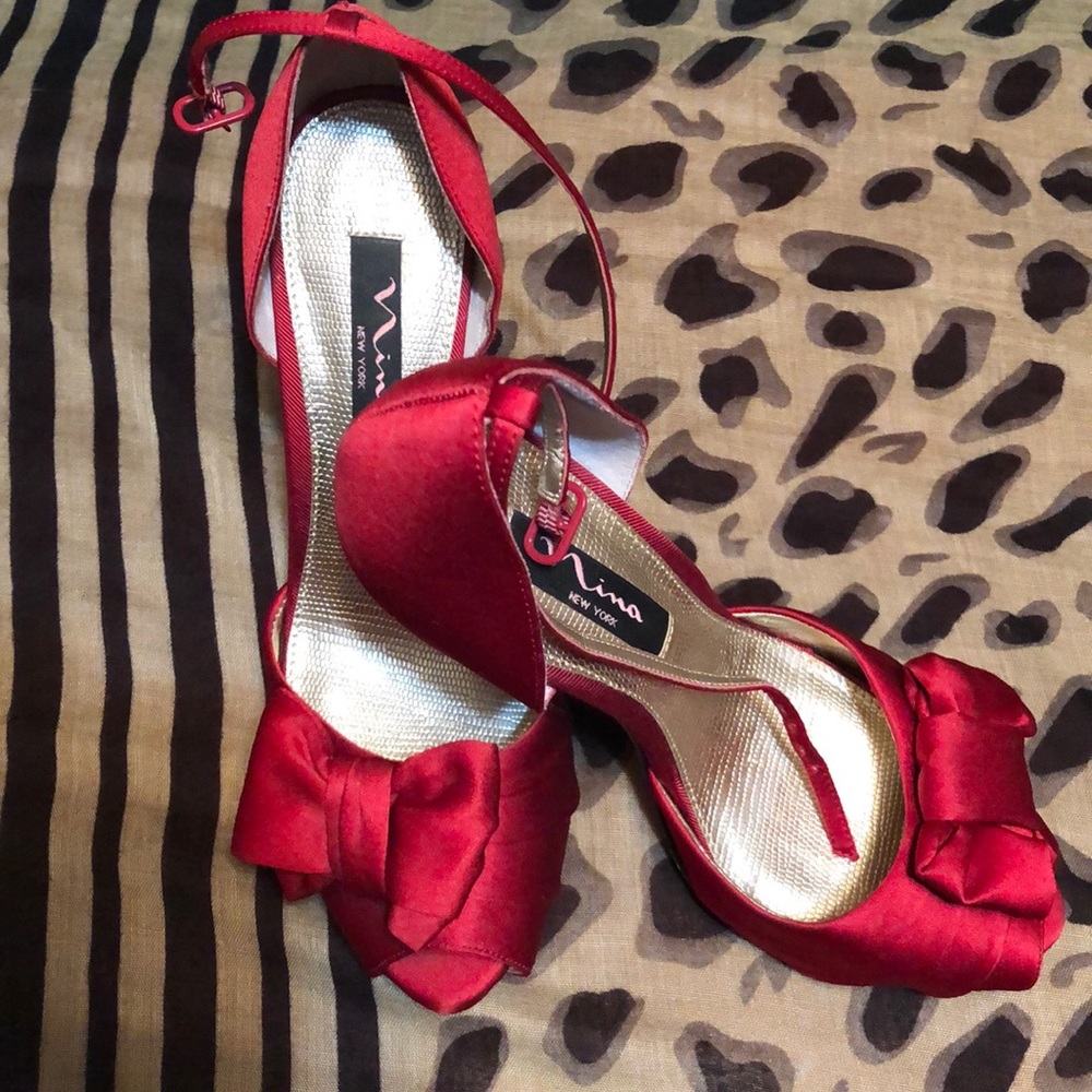Red satin peep toe pumps by Nina New York